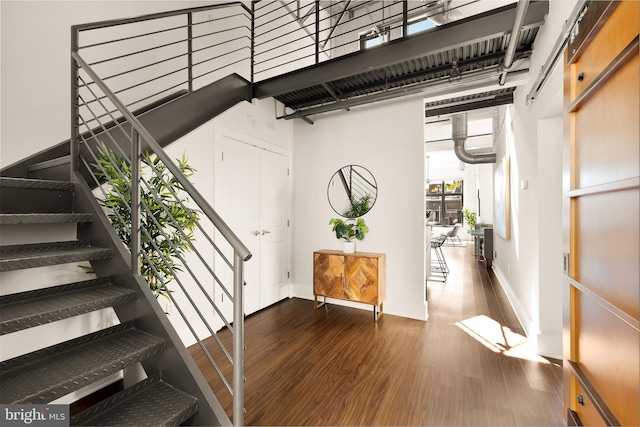 stairway featuring baseboards and wood finished floors