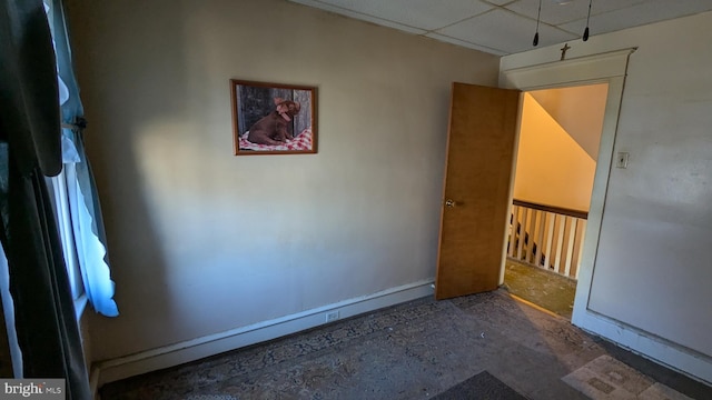 spare room featuring a paneled ceiling