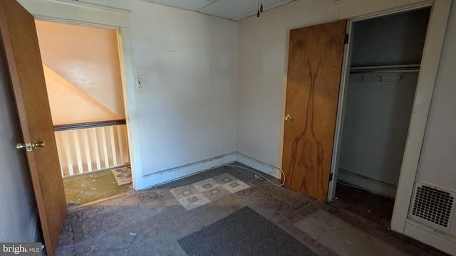 unfurnished bedroom featuring visible vents and a closet