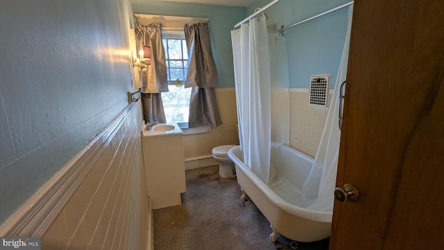 full bath featuring wainscoting, vanity, visible vents, and tile walls