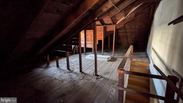 unfinished attic featuring an upstairs landing