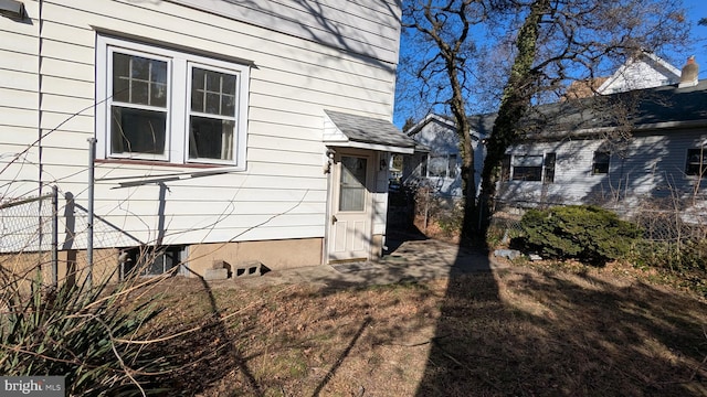 view of home's exterior featuring fence