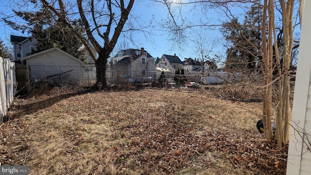 view of yard featuring a residential view and fence