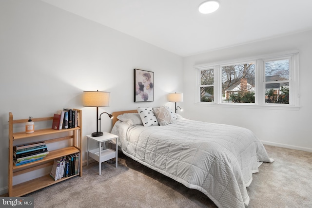 bedroom featuring carpet floors and baseboards