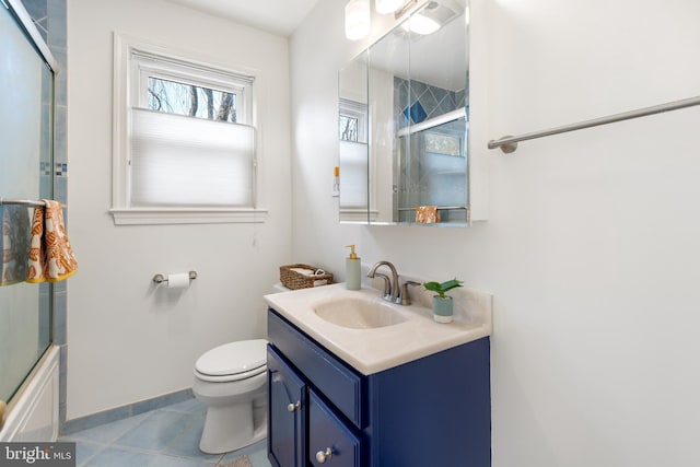 full bath with toilet, tile patterned floors, baseboards, and vanity