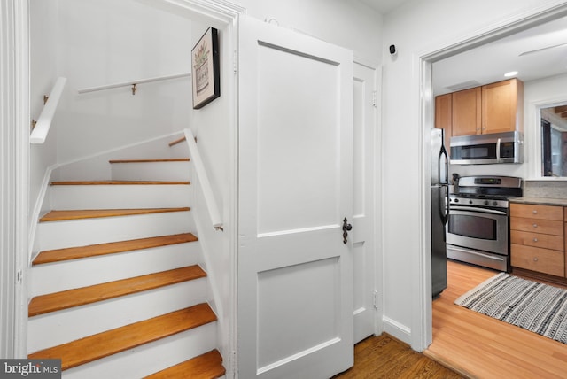 staircase with wood finished floors