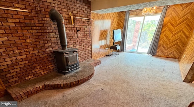 unfurnished living room featuring carpet floors, a wood stove, and wooden walls