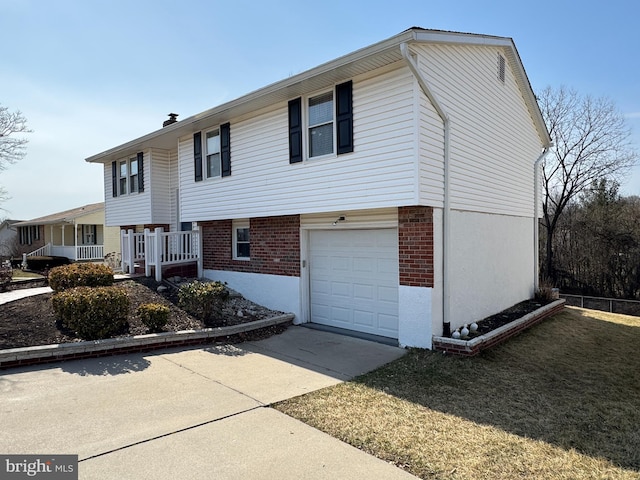 view of front of house featuring concrete driveway, brick siding, and an attached garage