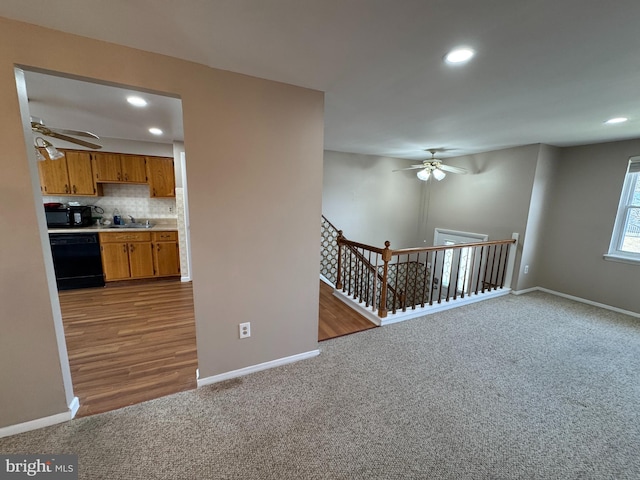 interior space with recessed lighting, a sink, and baseboards