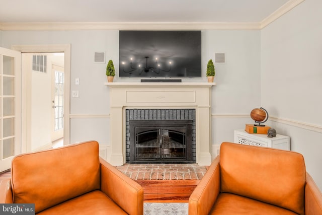 sitting room with ornamental molding, a brick fireplace, and visible vents