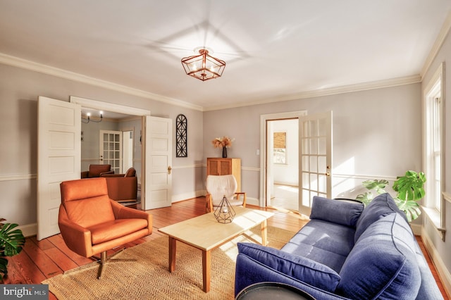 living room with ornamental molding, french doors, baseboards, and hardwood / wood-style flooring