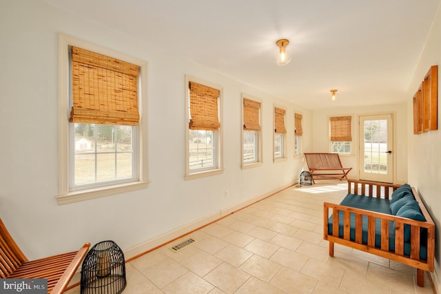 living area with visible vents, baseboards, and light tile patterned flooring