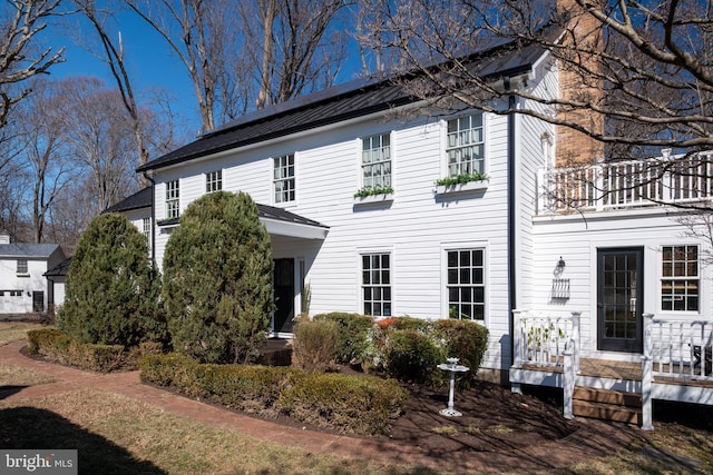 colonial-style house with a balcony