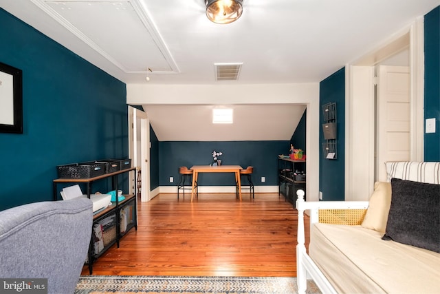 rec room with visible vents, attic access, vaulted ceiling, wood finished floors, and baseboards