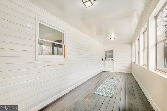 unfurnished sunroom with plenty of natural light