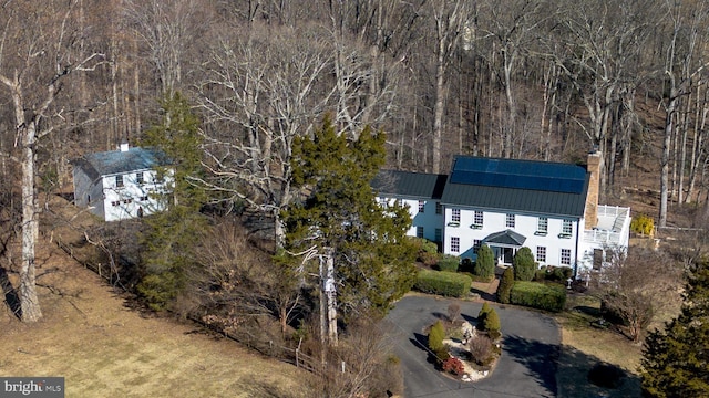 bird's eye view with a wooded view