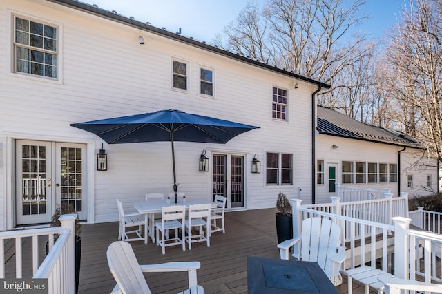 wooden terrace featuring outdoor dining space and french doors