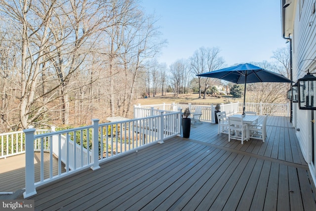 wooden terrace with outdoor dining space