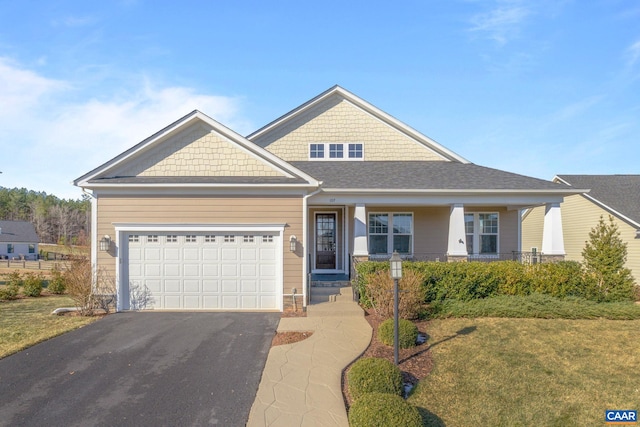 view of front of house with a garage, aphalt driveway, and a porch