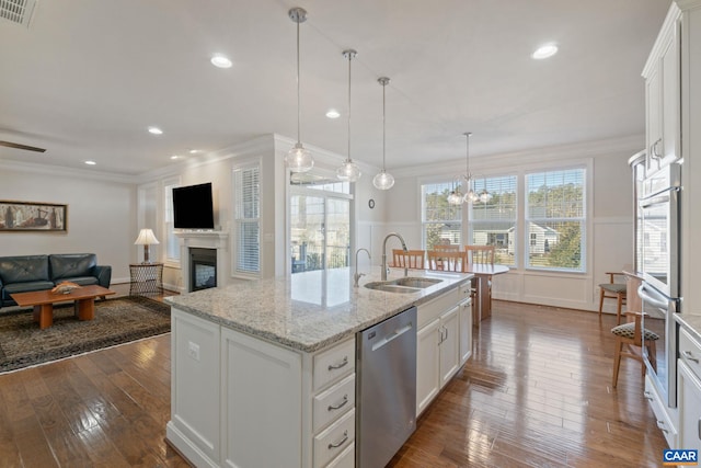 kitchen featuring a fireplace, a sink, visible vents, stainless steel dishwasher, and crown molding