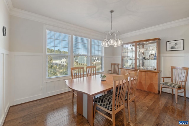 dining area with ornamental molding, a wainscoted wall, and hardwood / wood-style floors