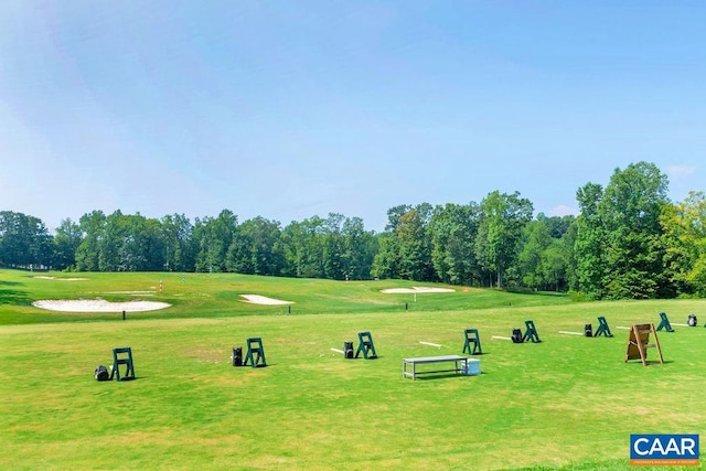 surrounding community featuring a yard and view of golf course