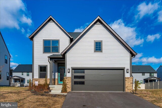 7508 Blue Sun Dr, Glen Burnie, MD 21060 - view of front facade featuring driveway, an attached garage, and brick siding