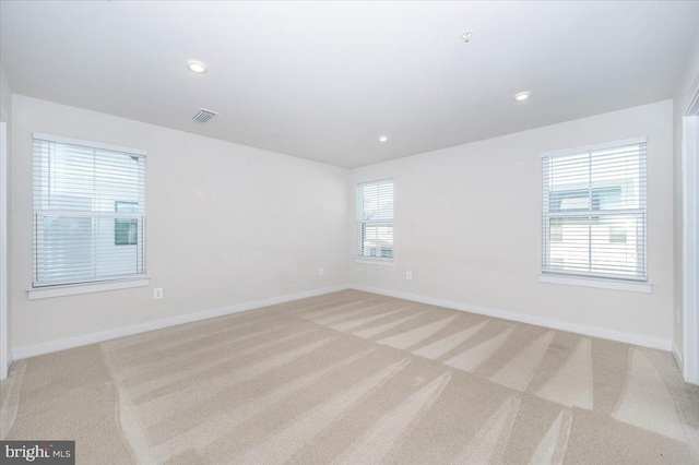 7508 Blue Sun Dr, Glen Burnie, MD 21060 - empty room featuring light carpet, visible vents, and baseboards