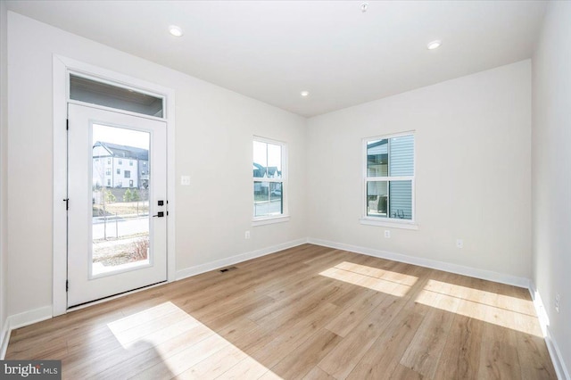 7508 Blue Sun Dr, Glen Burnie, MD 21060 - doorway to outside with baseboards, recessed lighting, visible vents, and light wood-style floors
