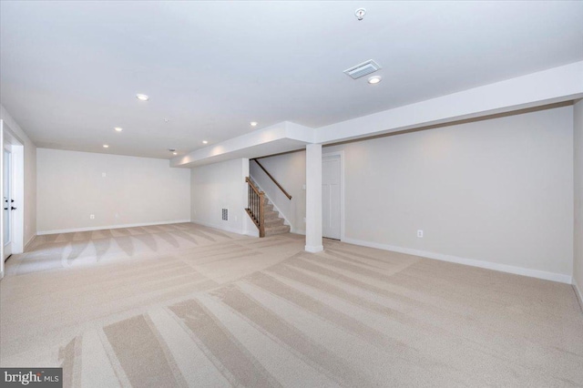 7508 Blue Sun Dr, Glen Burnie, MD 21060 - finished below grade area with light carpet, visible vents, stairway, and recessed lighting