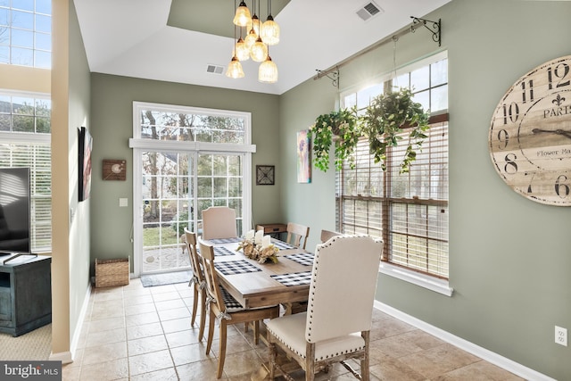 dining room with a chandelier, visible vents, and baseboards