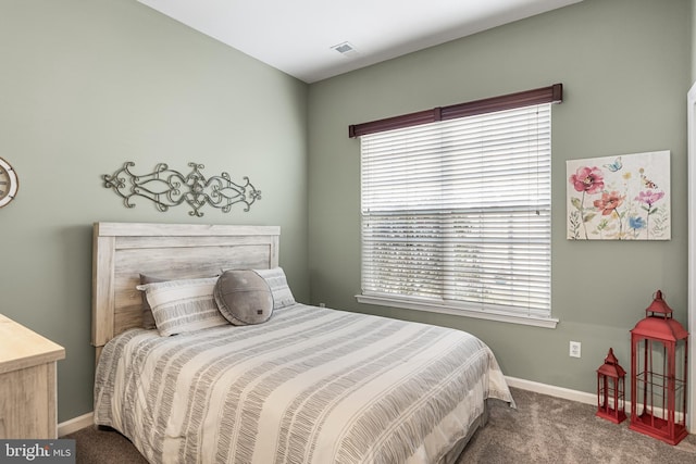 bedroom with carpet, multiple windows, and baseboards