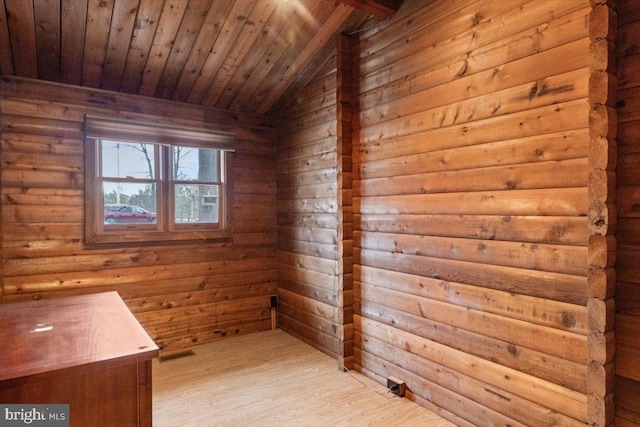 interior space featuring lofted ceiling, wooden ceiling, wooden walls, and wood finished floors