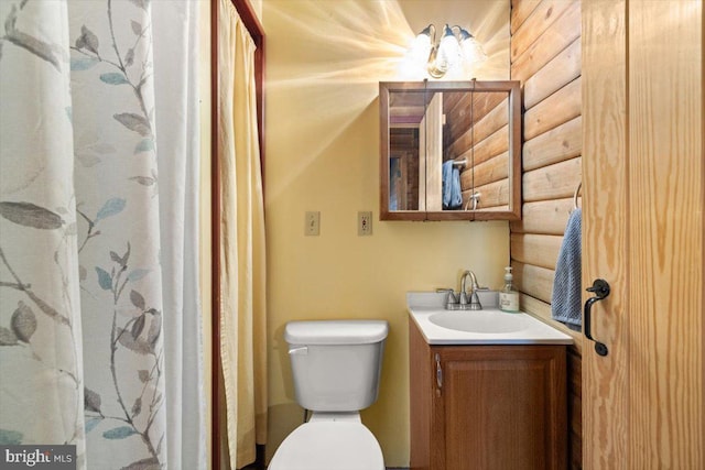 full bathroom featuring toilet, vanity, log walls, and a shower with curtain