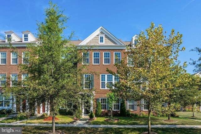 townhome / multi-family property with brick siding