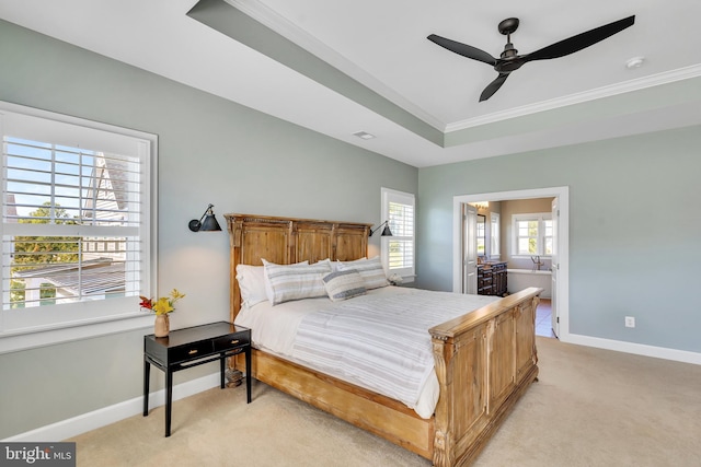 bedroom with baseboards, a ceiling fan, light colored carpet, a tray ceiling, and crown molding