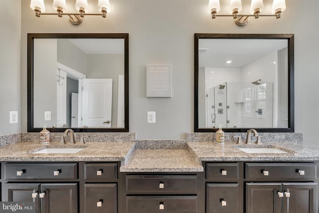 full bath featuring double vanity, a stall shower, and a sink