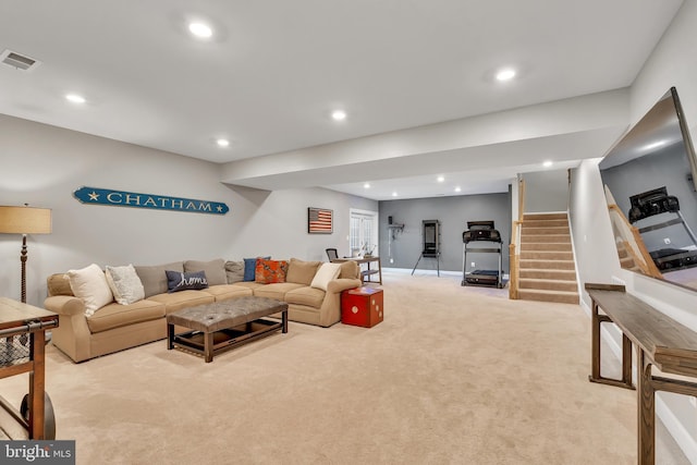 living area with recessed lighting, light colored carpet, visible vents, and stairs