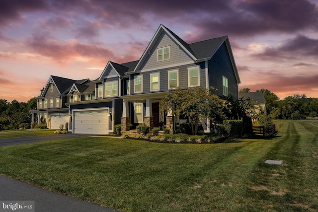 view of front of property with aphalt driveway, a porch, a garage, stone siding, and a front lawn