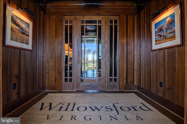 entryway featuring wooden walls