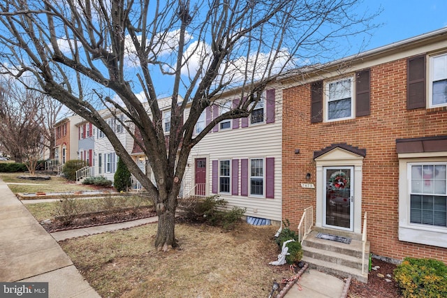 view of property featuring brick siding