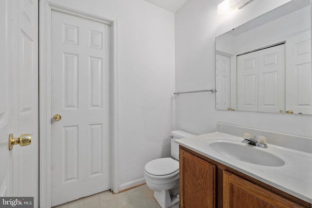 bathroom featuring vanity, toilet, and tile patterned floors