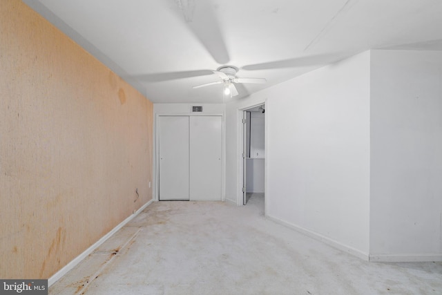 unfurnished bedroom with a ceiling fan, a closet, and baseboards