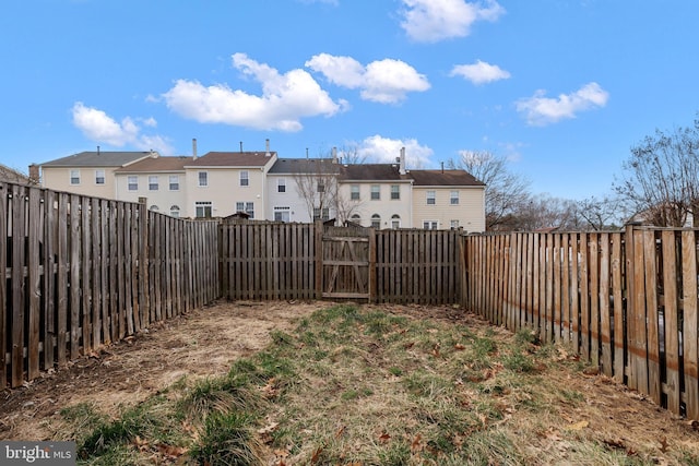 view of yard with a residential view and a fenced backyard