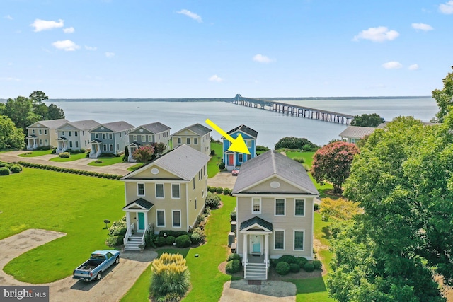 drone / aerial view with a water view and a residential view