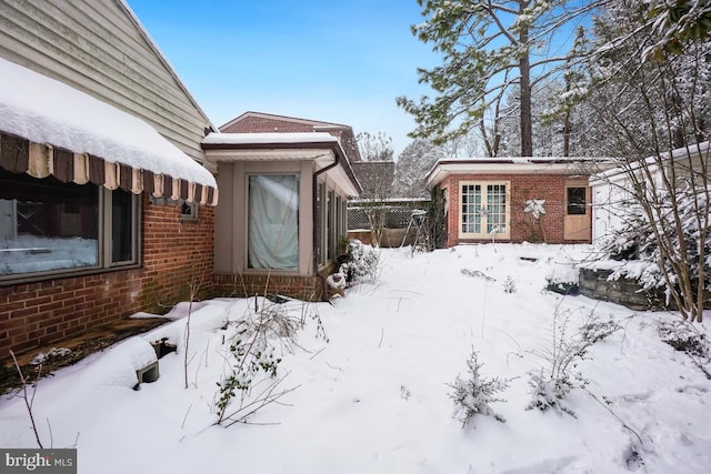 snowy yard featuring an outdoor structure