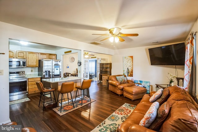 living room featuring visible vents, ceiling fan, and dark wood-style flooring