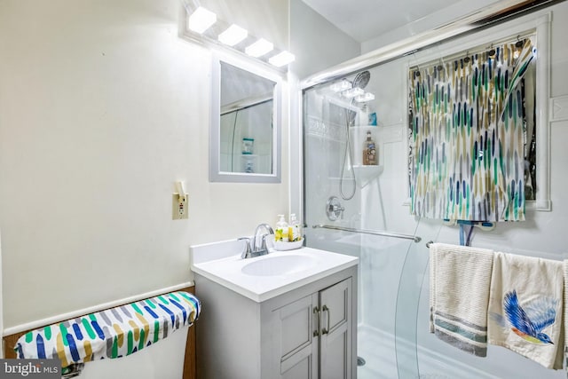 full bathroom with a stall shower and vanity