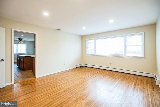 spare room with light wood-style flooring, recessed lighting, visible vents, baseboards, and baseboard heating