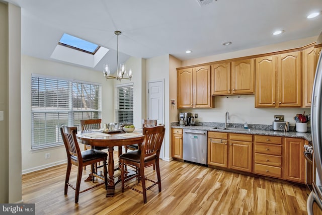 kitchen with light wood-style floors, dishwasher, stone counters, a sink, and recessed lighting